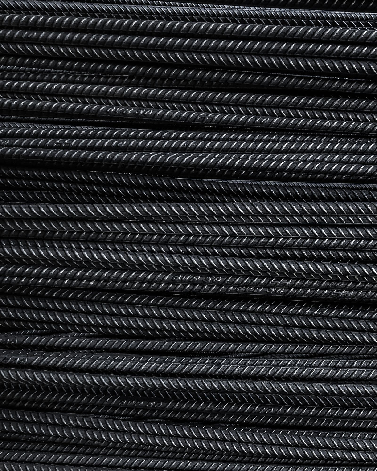 Close-up of stacked steel bars showing dense industrial stock